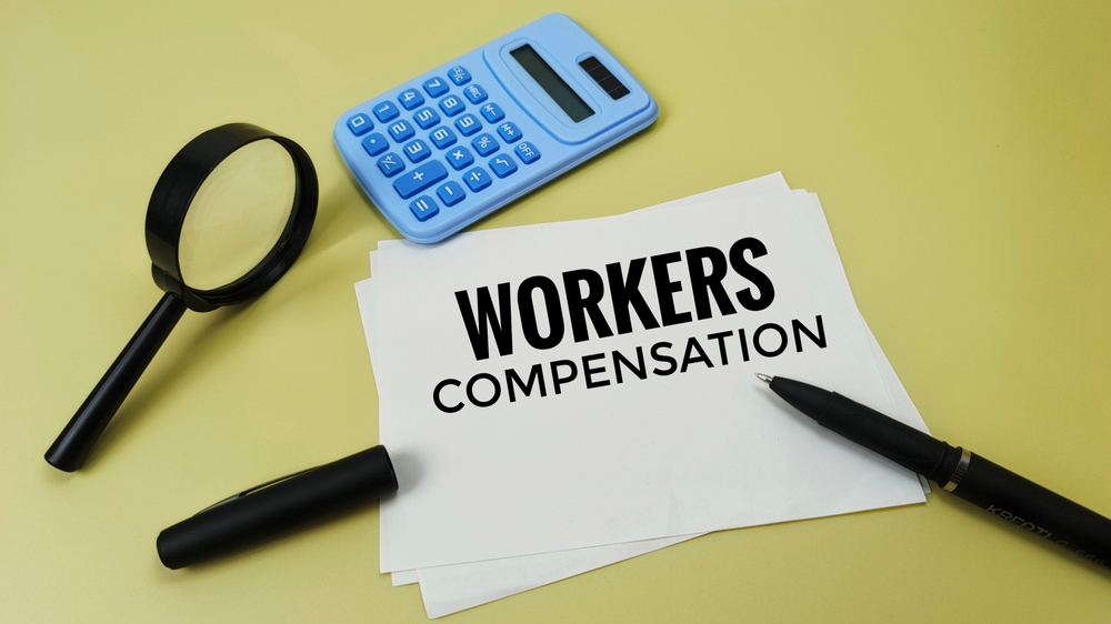 Workers,Compensation,Concept,With,Calculator,And,Black,Pen,Symbolizing,Employee